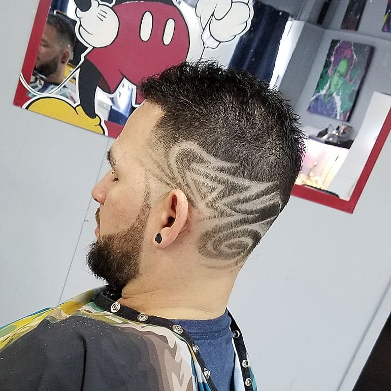 Detailed curved design shaved into a short haircut at Medina’s